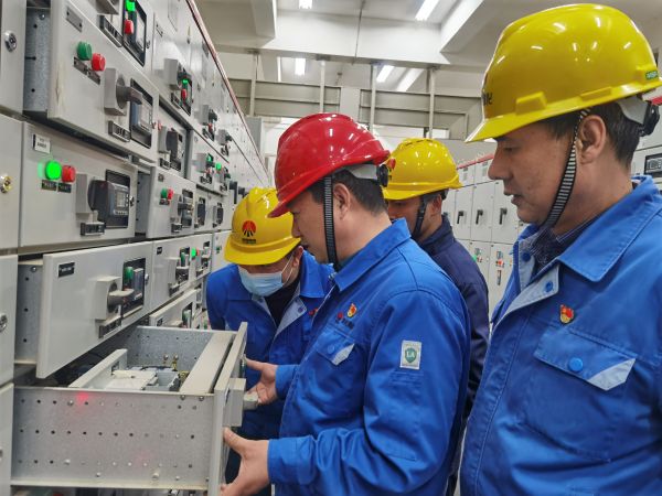 3月16日，對標(biāo)交流現(xiàn)場，大家圍在一起對配電室開關(guān)柜查找差距與優(yōu)勢.jpg